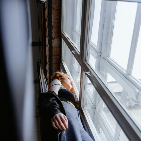 Person meditating peacefully in a bright, clean room.